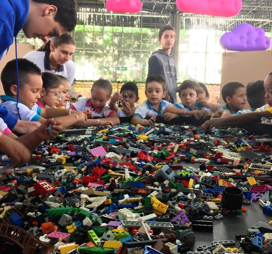  TCS students teaching kids LEGO from surrounding schools.
