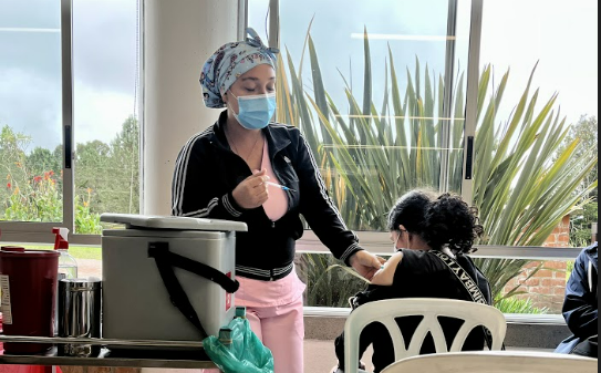 Nurse vaccinating student at TCS elementary office