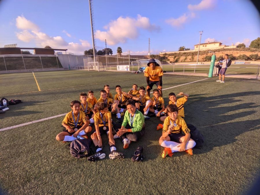TCS 7th Grade futbol team rest after winning the 7th place playoff match against TASIS Portugal, 4-0.