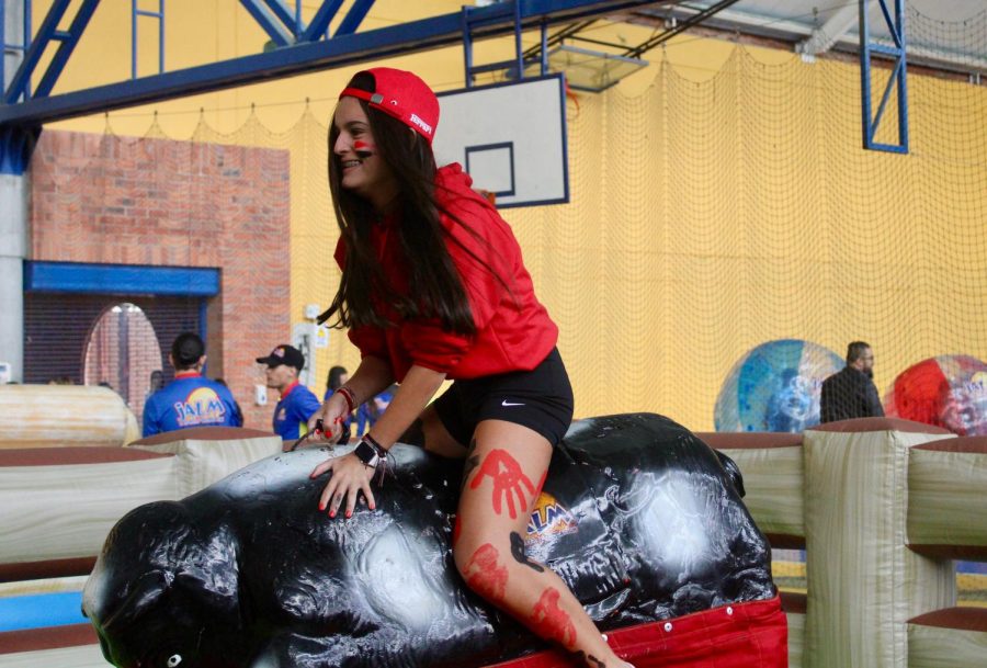 Middle school student rides the mechanical bull in the HS coliseum. Alongside Jalm Sport and Recreation, TCS prepared an eventful day for students from K4 to Grade 12, with different attractions such as the Mechanical Bull, the Big Twist, Bubble Football, Soapy Tracks, Tug-a-war, and lastly, a fan-favorite, the 3D simulator.