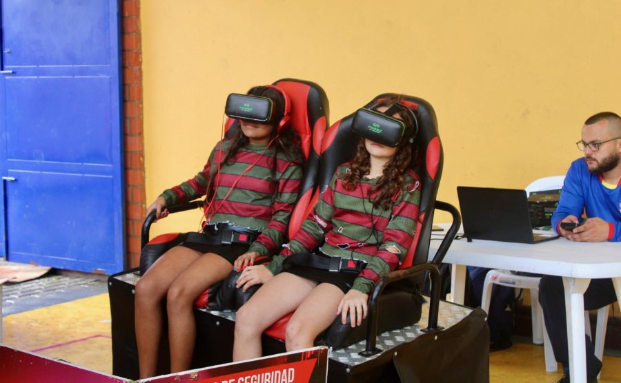 Two Middle School students are entertained by the 3D simulator in the HS coliseum. This year, the newest and most long-awaited attraction was the 3D simulator. This allowed students to experience a mix of speed, laughter, adrenaline, and the impression of a real roller coaster all at once.