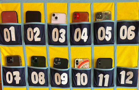 Student cell phones in their pouches in an AP Physics classroom. Students place their phones in the pockets at the start of class to reduce distractions.