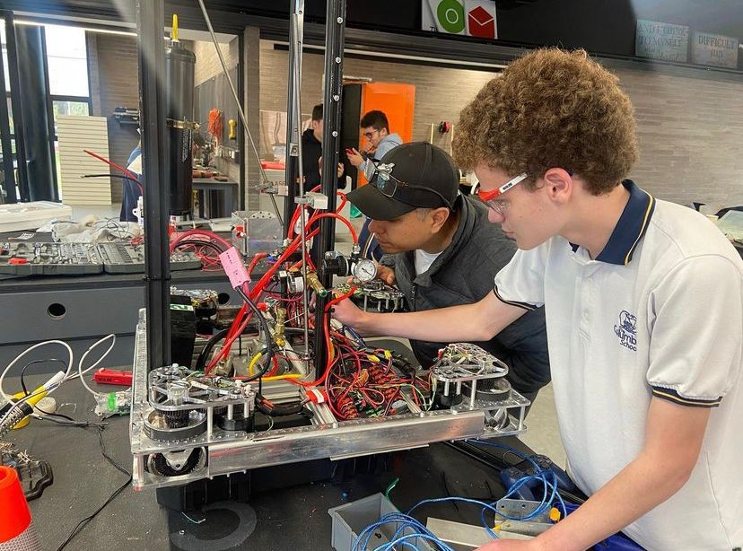 FRC team members, Gregorio Velez and Julian Zuñiga put the final touches to the robot before the competiton. The team competes in Miami on March 1. 