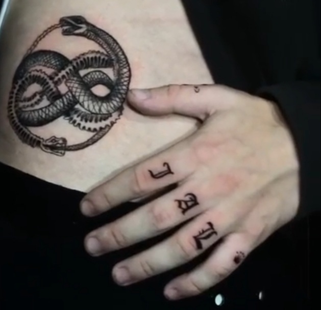 Andres Gaviria, Grade 11, shows his tattoos. 
On my hand I tattooed the initials of my parents and mine,  the snake means that everything is a cycle because it is a snake that eats itself, Gaviria said.

