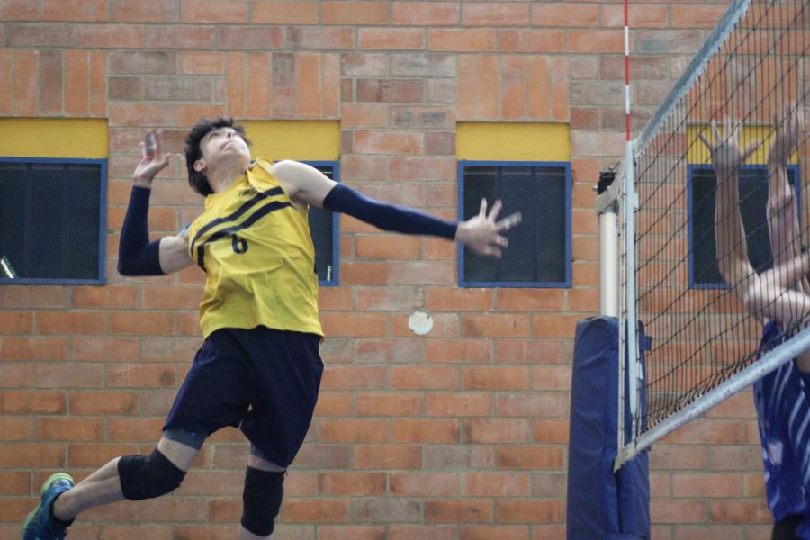 Middle blocker David Fajardo greets the annual Copa Columbus games with an impressive spike. Although San Ignacio managed to win the point, TCSs performance throughout the majority of the game, TCS ultimately came out victorious in the first match.