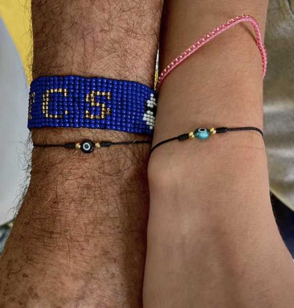 Hernan+Arango+and+Isabel+Mejia%2C+along+with+all+the+girls+soccer+team+members%2C+proudly+wear+the+evil+eye+bracelet.+These+bracelets%2C+gifted+by+the+team+captain+during++Binationals%2C+symbolize+the+unity+within+the+team+and+highlight+how+its+like+a+family.