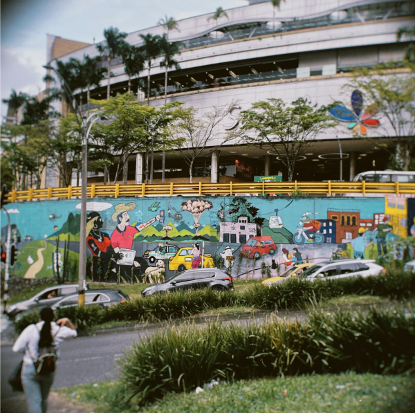 In front of Santa Fe, a mall in El Poblado, lays a stop for The Graffiti Tour. This excursion depicts a rejuvenated Medellín that has accepted new forms of expression and peaceful existence through music and street art. The trip provides an overview of Medellíns active street life, with its bright graffiti representing the communitys history and resilience. The vibrant paintings and rhythmic beats depict a communal story, demonstrating art and musics transformational power in defining the cultural identity of Medellíns neighborhoods.
