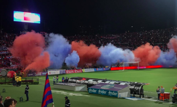 Deportivo Independiente Medellín fans (Rexixtencia Norte) release fire extinguishers as the team enter the field. A tradition to demonstrate support to the players. 