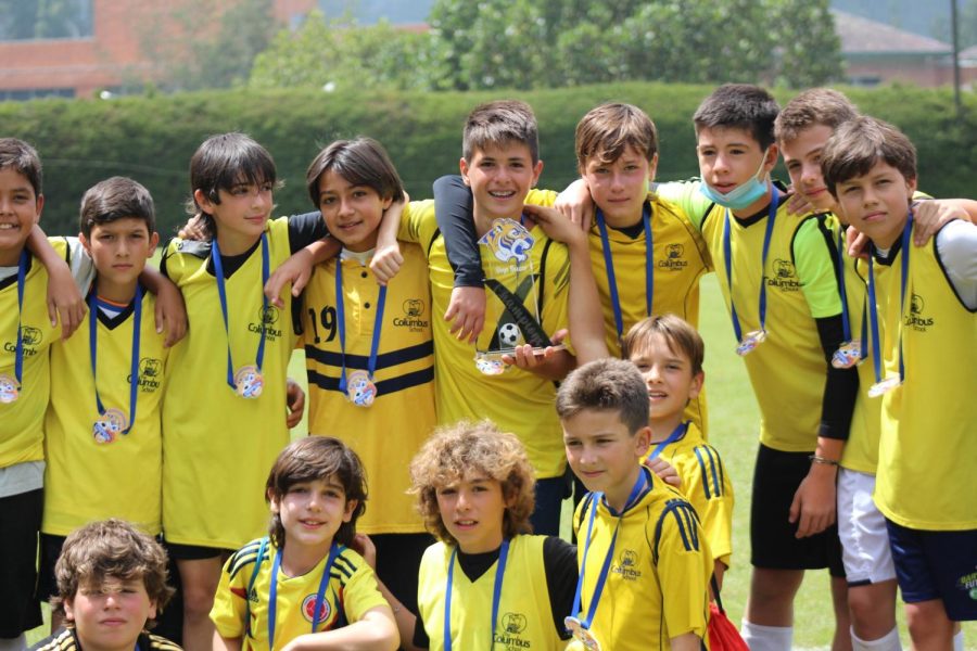 TCS MS Boys Football Team receiving their prices after winning the final. Emilio Aristizabal, the team captain, is holding the trophy with his teammates by his side.