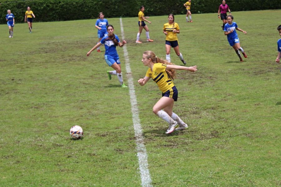 The TCS Girls futbol team in action on April 8. The team defeated Colegio Theodoro Hertzl 5-0 in the finals.