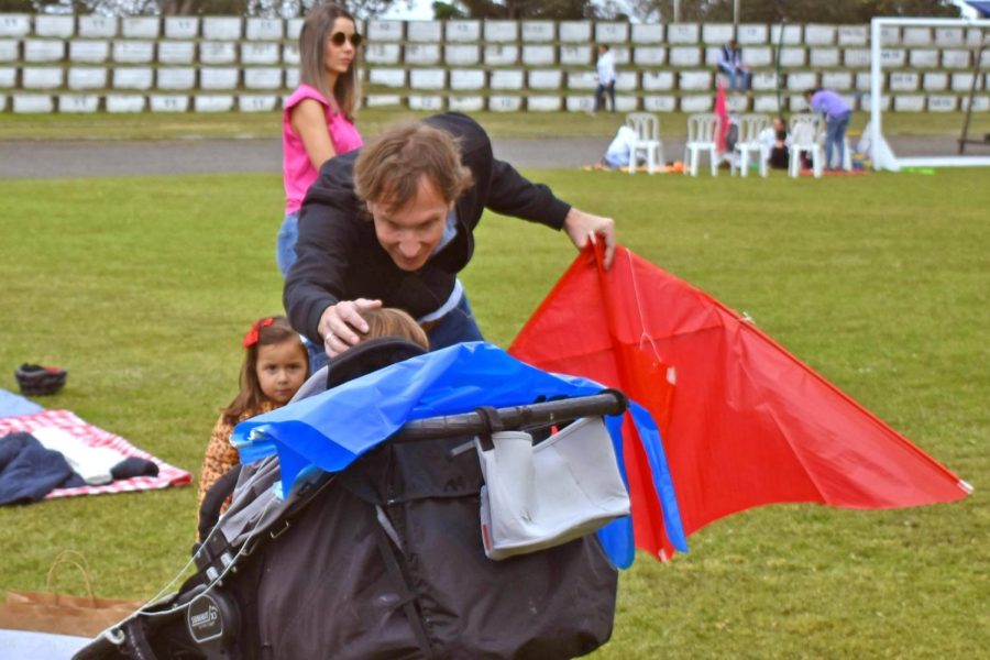 A TCS parent reassures a baby that kites aren’t harmful. Before this moment, the baby had been a bit hesitant to be around kites. 
