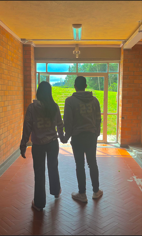 A couple walk together  through the high school.