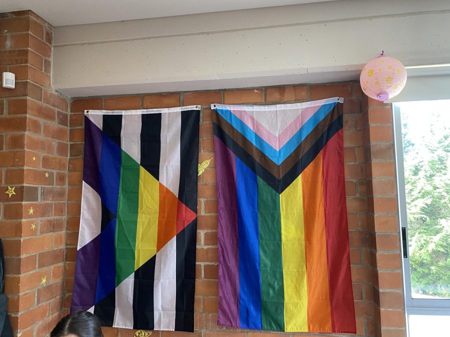 A flag representing the LGBTQ+ community and the Gay-Straight Alliance hang in a high school classroom. 