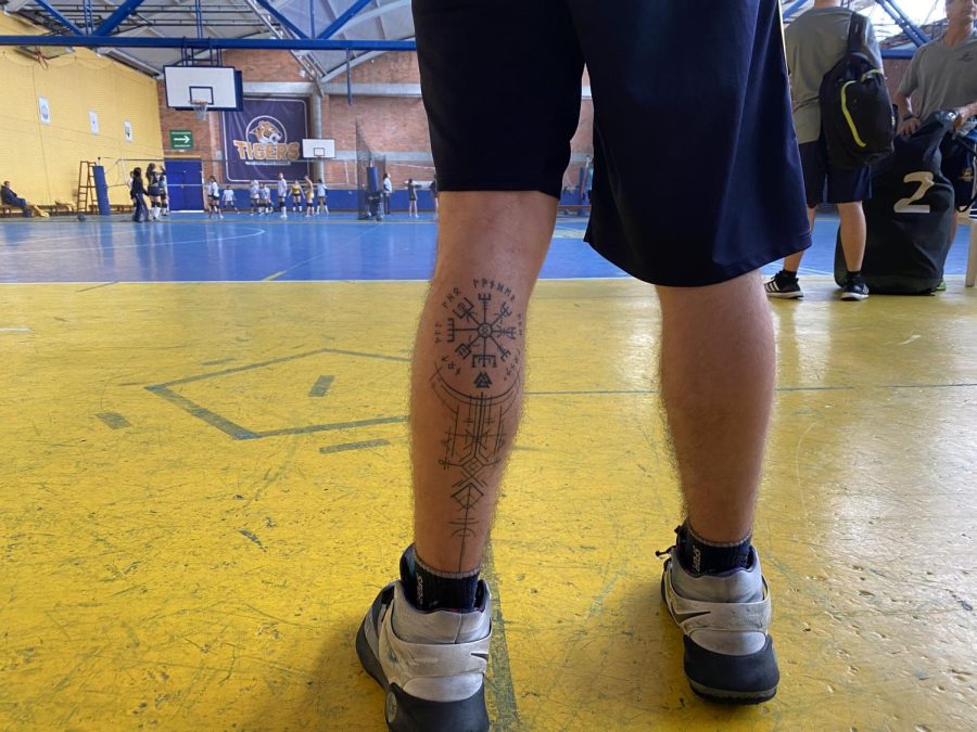 Miguel Romero’s Viking Compass tattoo on display while playing basketball. 