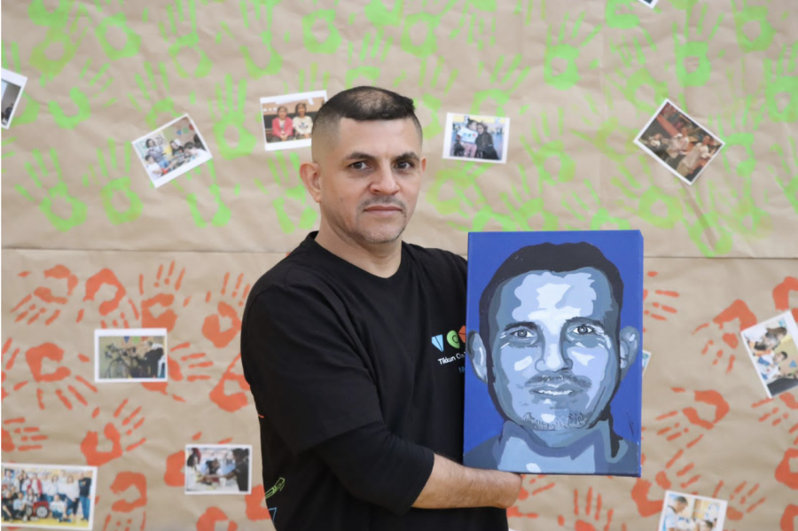 TOM Need Knower Rigoberto Zapata poses with his portrait at the TOM 2023 event held at TCS April 20-22. 