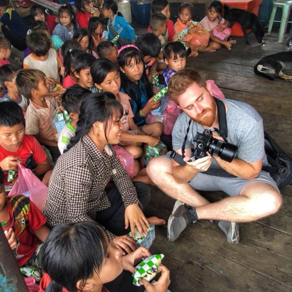 Andrew Shainker volunteering in Cambodia, teaching students about photography